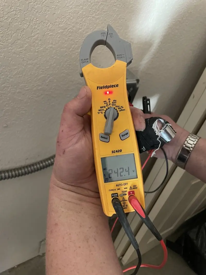 Voltage testing with clamp meter during Ceiling Fan Installation in Elba